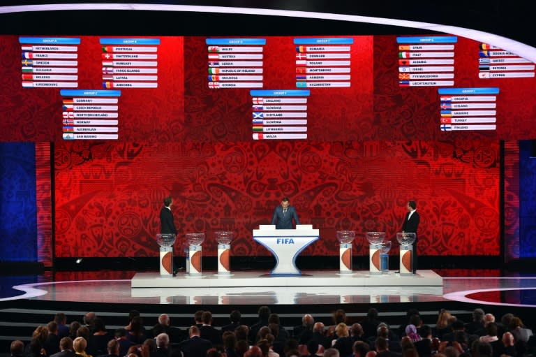 (L-R) Oliver Bierhoff, Jerome Valcke and Alexander Kerzhakov present the preliminary draw for the Union of European Football Associations zone for the 2018 World Cup qualifiers in Saint Petersburg on July 25, 2015