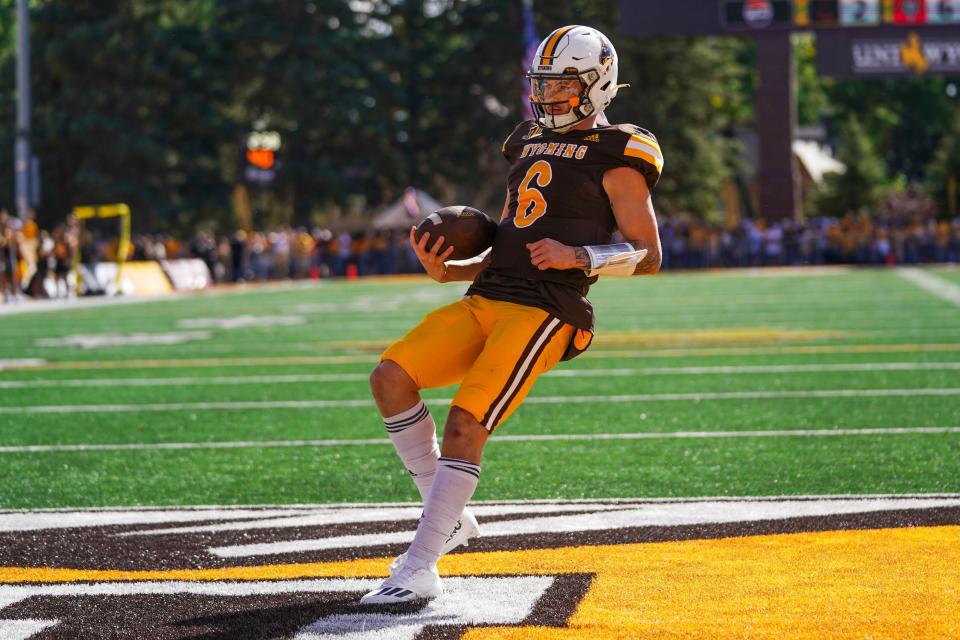 Sep 30, 2023; Laramie, Wyoming, USA; Wyoming Cowboys quarterback Andrew Peasley (6) scores a touchdown against the New Mexico Lobos during the first quarter at Jonah Field at War Memorial Stadium. Mandatory Credit: Troy Babbitt-USA TODAY Sports