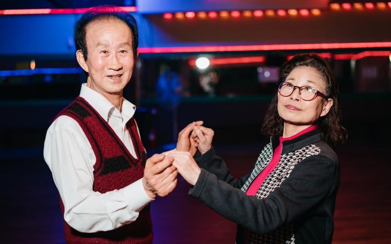 Dance instructor Jung Seok-jo, 72, left, with his dancing partner at a discotheque for seniors in northern Seoul - Â© Jun Michael Park. All Rights