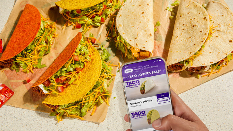 'Taco lover's pass' on phone held over tacos