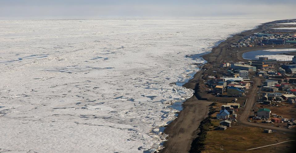 An aerial view of the arctic ice from above Barrow, Alaska. Officials have sought to protect Barrow, which is fewer than 15 feet above sea level, by moving municipal buildings and lining the coast with berms and sandbags.