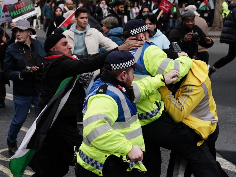 Police officers clash with rival supporters in Whitehall on Saturday (PA)