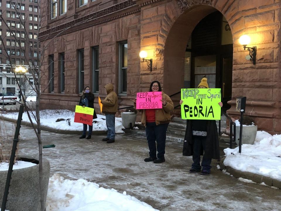 Protesters gather outside Peoria City Hall ahead of Tuesday night's council meeting in an effort to draw attention to the potential sale of the Spirit of Peoria riverboat.