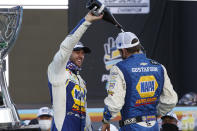 Chase Elliott, left, and pit crew chief Alan Gustafson celebrate their season championship in Victory Lane after winning a NASCAR Cup Series auto race at Phoenix Raceway, Sunday, Nov. 8, 2020, in Avondale, Ariz. (AP Photo/Ralph Freso)