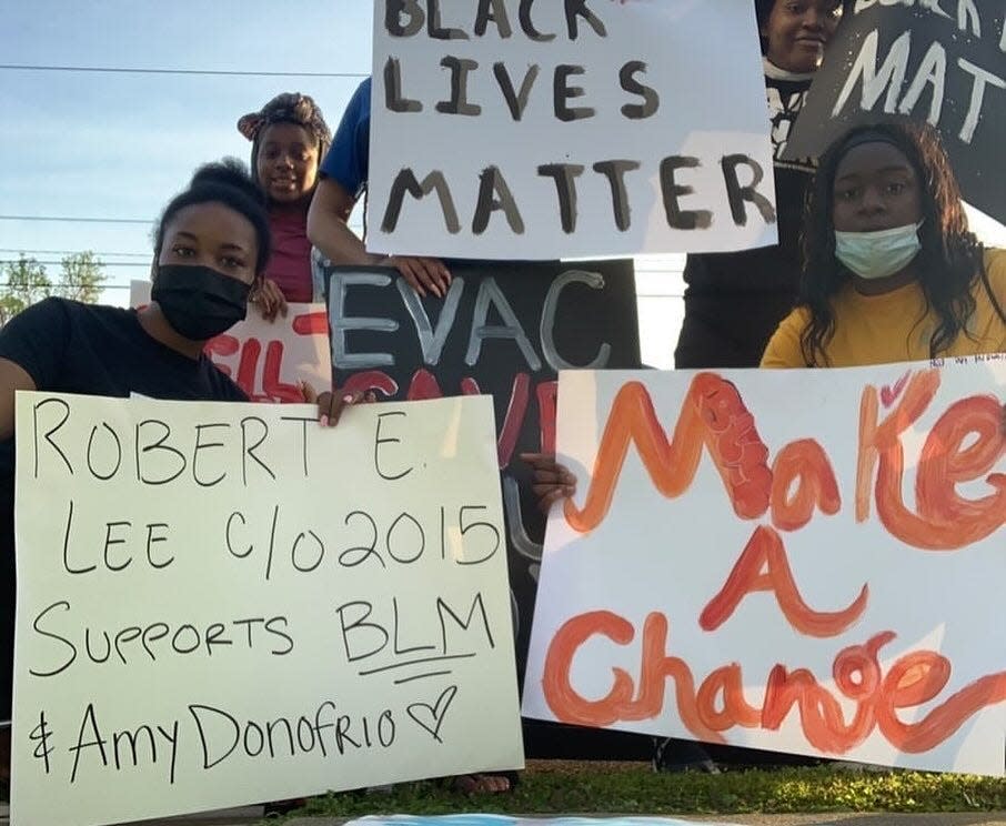 Members of the Jewels of the Future nonprofit and other supporters of Jacksonville teacher Amy Donofrio protest her removal from the classroom after displaying a Black Lives Matter flag.