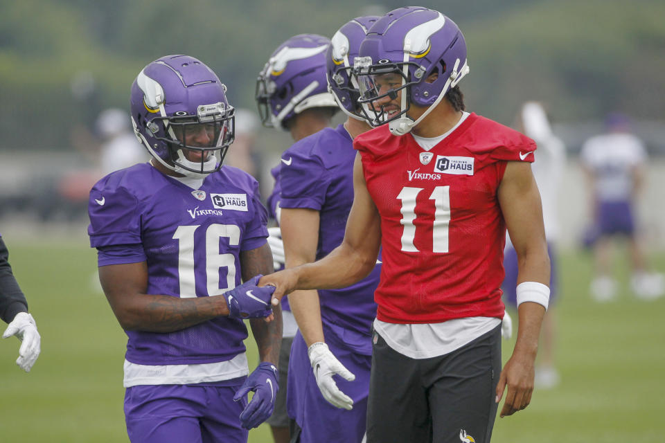 Minnesota Vikings wide receiver Whop Philyor (16) and quarterback Kellen Mond (11) enjoy a good play during NFL football training camp Friday, July 30, 2021, in Eagan, Minn. (AP Photo/Bruce Kluckhohn)