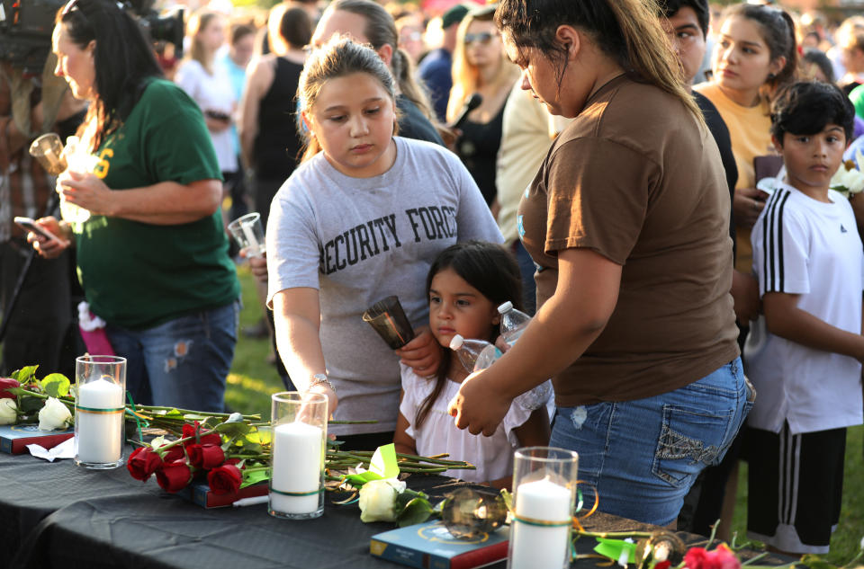 Community members honor the victims of Friday's mass shooting at Santa Fe High School in Texas. (Photo: Trish Badger/Reuters)