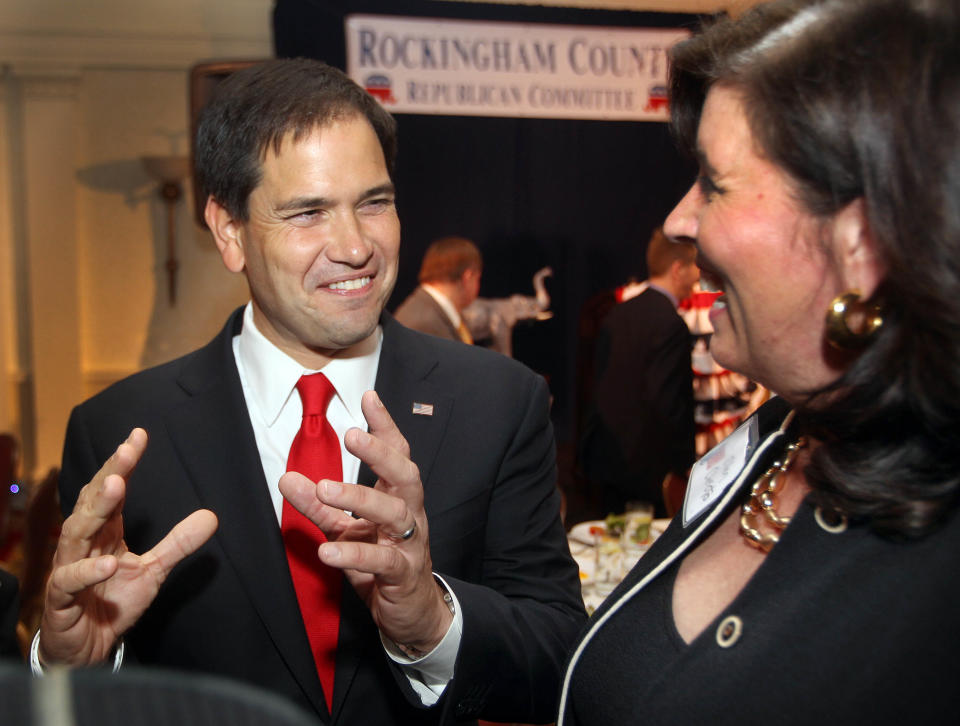 U.S. Sen. Marco Rubio, R-Fla., left, speaks with New Hampshire Republican Chairwoman Jennifer Horn at the Rockingham County Republican Committee's Freedom Founders Dinner, Friday, May 9, 2014 in New Castle, N.H. (AP Photo/Jim Cole)