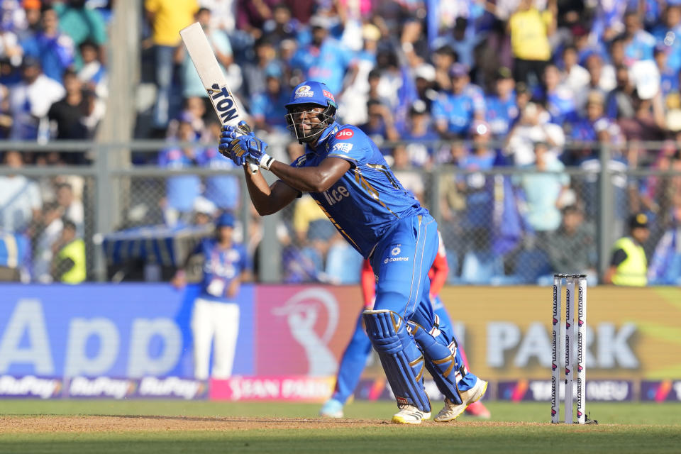 Mumbai Indians' Romario Shepherd plays a shot during the Indian Premier League cricket match between Mumbai Indians' and Delhi Capitals' in Mumbai, India, Sunday, April. 7, 2024.(AP Photo/ Rafiq Maqbool)