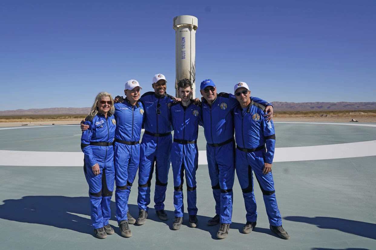 Laura Shepard Churchley, Dylan Taylor, Michael Strahan, Cameron Bess, Lane Bess and Evan Dick pose for a photo in front of the booster rocket (LM Otero/AP)