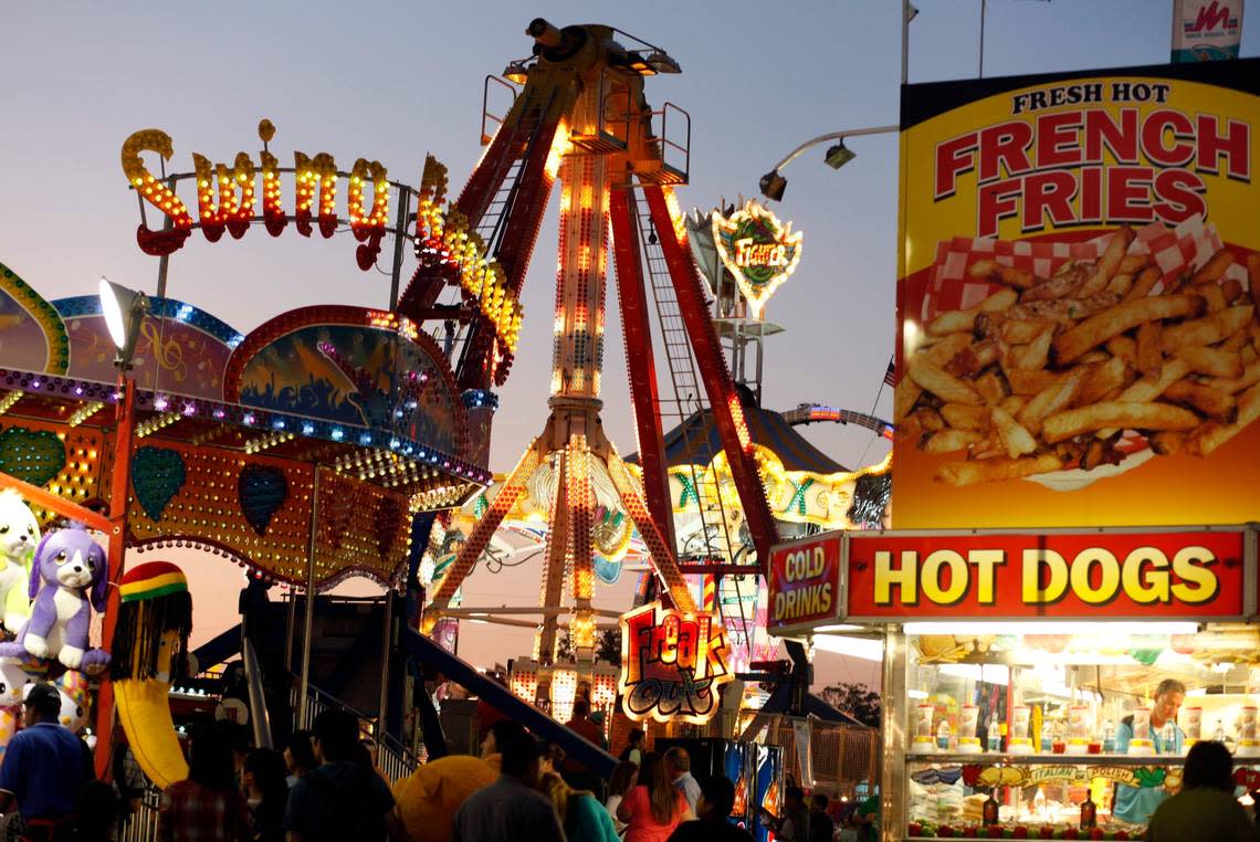 The lights from rides, food trailers, and games light the midway of the N.C. State Fair in Raleigh.