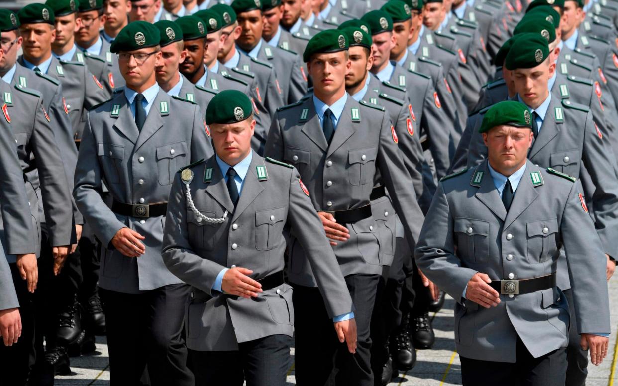 New recruits march on the parade ground during a swearing-in ceremony of German Bundeswehr soldiers at the German Defence Ministry in Berlin, on July 20, 2019 - AFP