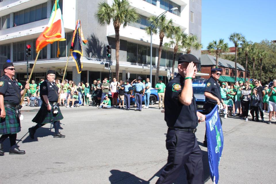Savannah police officers salute the marchers during the Savannah St. Patrick’s Day Parade on Thursday March 17, 2022.
