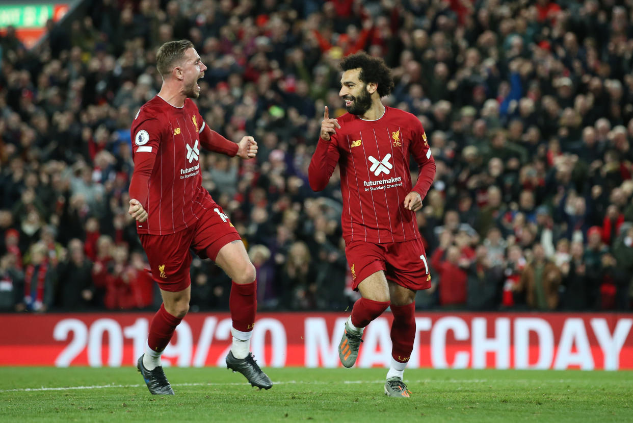 LIVERPOOL, ENGLAND - OCTOBER 27:  Mohamed Salah of Liverpool (11) celebrates as he scores his team's second goal from a penalty with Jordan Henderson during the Premier League match between Liverpool FC and Tottenham Hotspur at Anfield on October 27, 2019 in Liverpool, United Kingdom. (Photo by Jan Kruger/Getty Images)