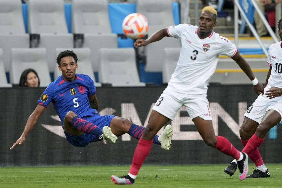 United States defender Bryan Reynolds kicks the ball past Trinidad and Tobago midfielder Joevin Jones during the first half of a CONCACAF Gold Cup soccer match on Sunday, July 2, 2023, in Charlotte, N.C. (AP Photo/Chris Carlson)