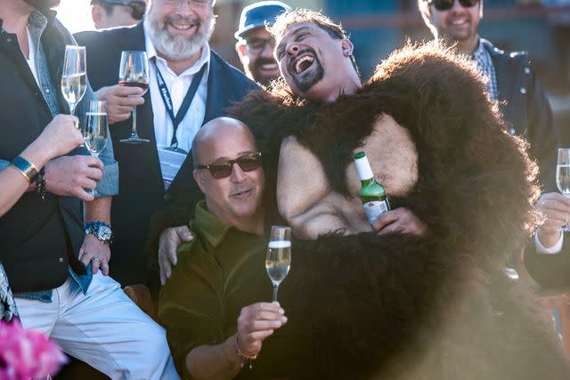 <p>Ken Goodman</p> Chris Cosentino, dressed as a gorilla, sits on Andrew Zimmern's lap