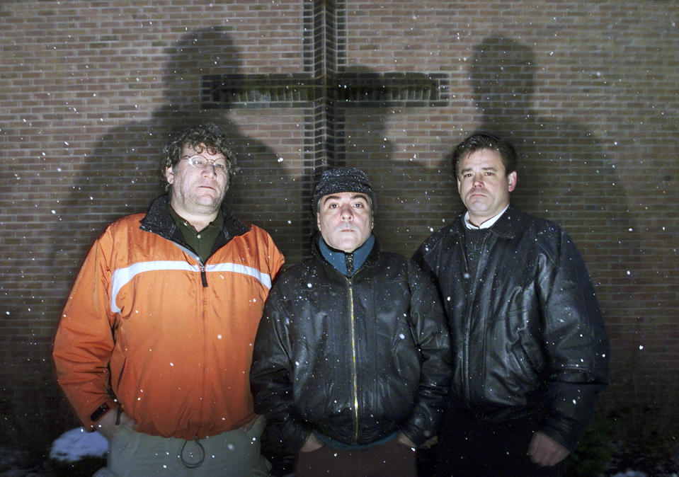 FILE - In this March 18, 2002, file photo, from left, Joe Ruggeri, Anthony Fernandes and Brian Condon stand outside of St. Lucy's Catholic Church in Middletown, R.I. All three said they were molested by Rev. James Silva when they were youth. Silva was listed by the Roman Catholic Diocese of Providence on Monday, July 1, 2019, as one of several members of clergy, religious order priests and deacons who have been credibly accused of sexually abusing children. (AP Photo/Victoria Arocho, File)