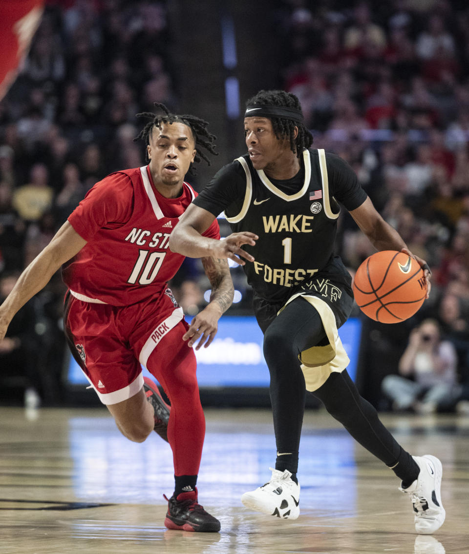 Wake Forest guard Tyree Appleby (1) moves around the defense of North Carolina State guard Breon Pass (10) in the first half of an NCAA college basketball game on Saturday, Jan. 28, 2023, in Winston-Salem, N.C. (Allison Lee Isley/The Winston-Salem Journal via AP)