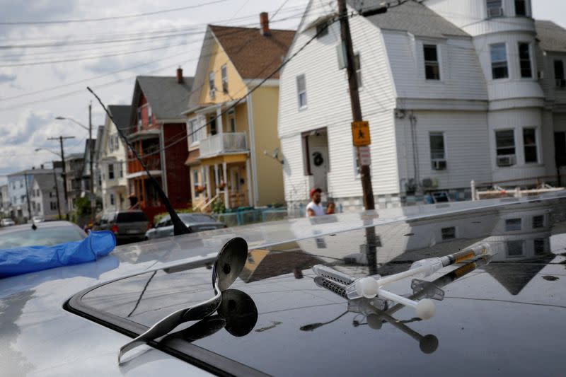 FILE PHOTO: A full syringe, empty syringe and spoon sit on the roof of the car in Lynn