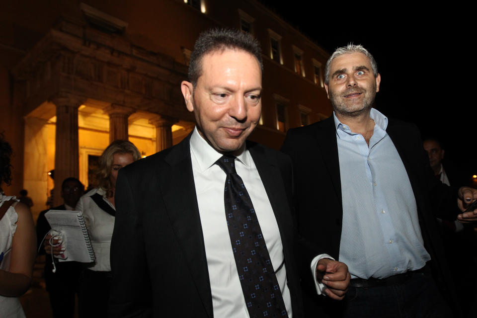 Greek Finance Minister, Yannis Stournaras, left, leaves the Greek parliament after a meeting between the heads of the three parties in the four-month-old, conservative-led coalition in Athens, Tuesday, Oct. 16, 2012. The head of a small center-left partner in Greece’s governing coalition on Tuesday ruled out new reforms demanded by bailout creditors, which he said would “crush” labor rights in the debt-crippled country. (AP Photo/Petros Giannakouris)