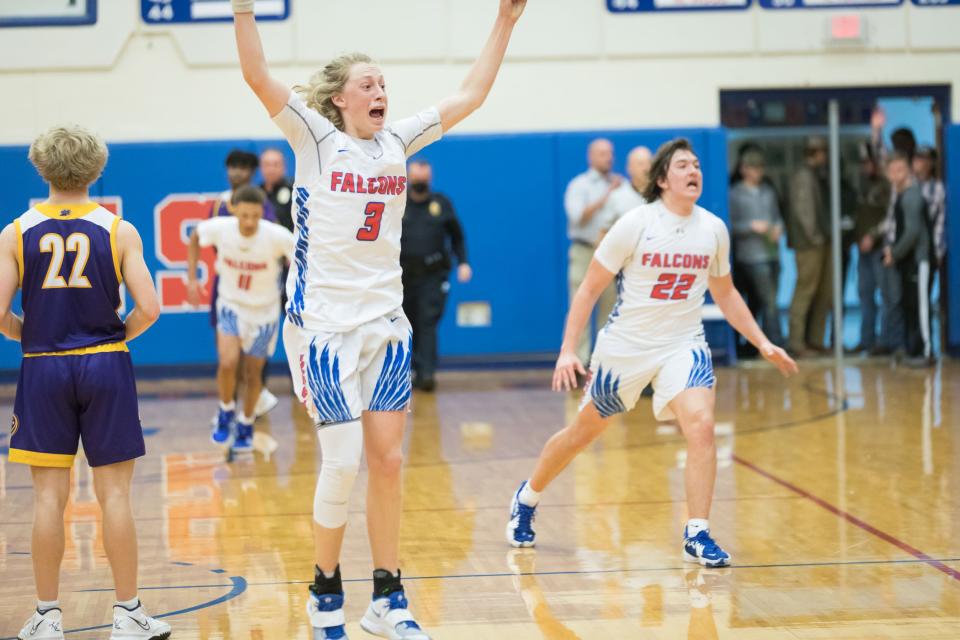 West Henderson's Jackson Lyda celebrates his shot that put the Falcons on top in the final seconds of Monday night's home game against North Henderson. West won 54-53.