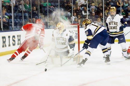 Notre Dame goaltender Ryan Bischel (30) makes the save on shot by Boston University forward Dylan Peterson (13) during the Boston University-Notre Dame NCAA hockey game on Friday, October 20, 2023, at Compton Family Ice Arena in South Bend, Indiana.