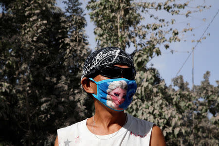 A resident wears a face mask after the Mayon volcano spews ash in Guniobatan, Albay Province, Philippines January 23, 2018. REUTERS/Stringer