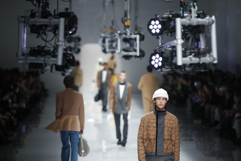 Models wear creations as part of the Fendi men's Fall-Winter 2020/21 collection, that was presented in Milan, Italy, Monday, Jan. 13, 2020. (AP Photo/Antonio Calanni)