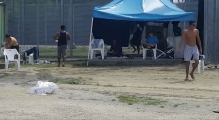 Asylum seekers are seen at a detention centre on Manus Island, Papua New Guinea, in this still image taken from social media video November 3, 2017. Abdul Aziz Adam/via REUTERS