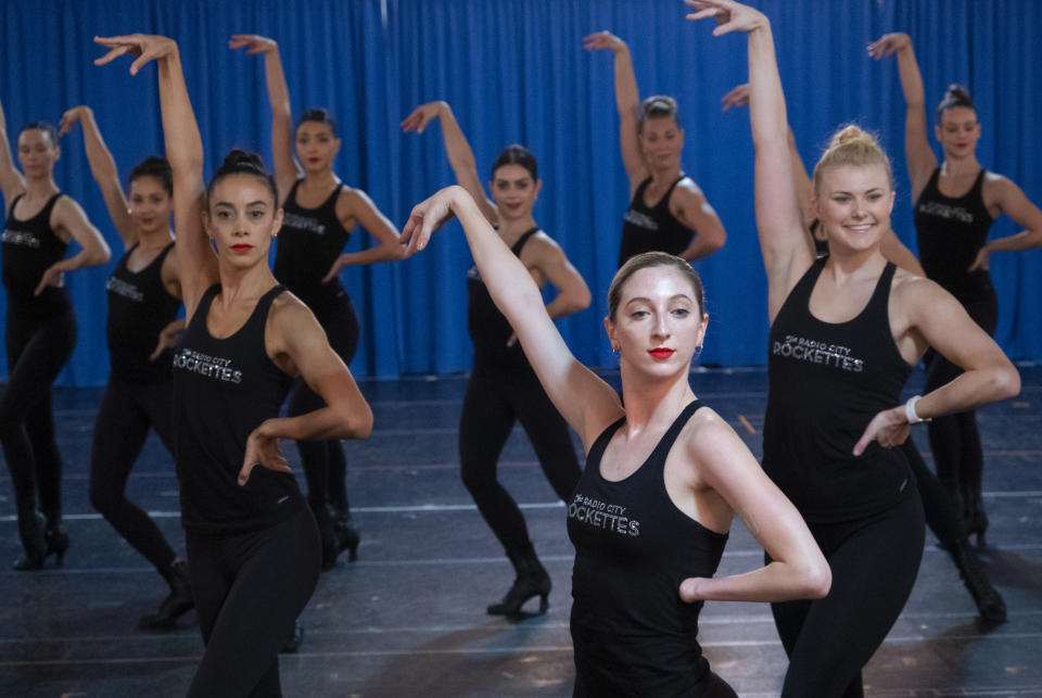 In this Oct. 22, 2019 photo, Rockette Sydney Mesher center right, takes part in a rehearsal at the Rockette's rehearsal space in New York. Mesher, who was born without a left hand due to the rare congenital condition symbrachydactyly, is the first person with a visible disability ever hired by New York's famed Radio City Rockettes. (AP Photo/Craig Ruttle)