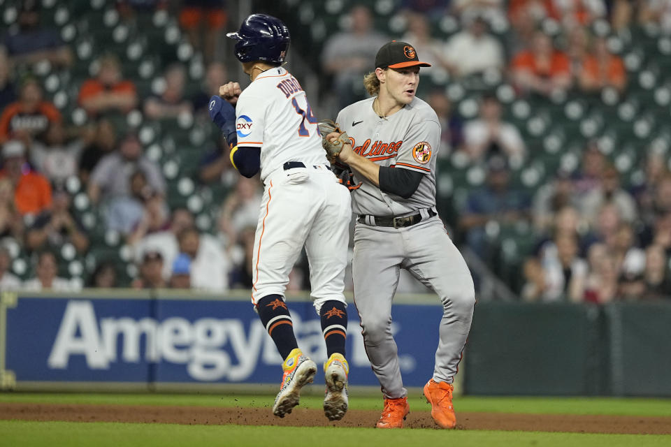 Houston Astros' Mauricio Dubon (14) is tagged out by Baltimore Orioles third baseman Gunnar Henderson during the ninth inning of a baseball game Tuesday, Sept. 19, 2023, in Houston. The Orioles won 9-5. (AP Photo/David J. Phillip)