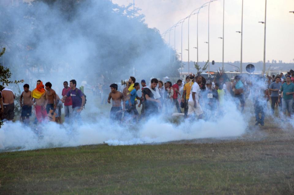 Police in the Brazilian capital fired tear gas to break up a protest by Indian chiefs and groups opposed to the money being spent to host the World Cup