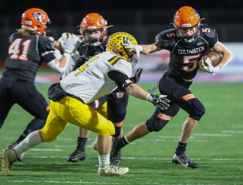 Coldwater's Marcel Blasingame tries to get by 
West Jefferson's Michael Pettry during the Division VI state semifinal Nov. 27 at Piqua.