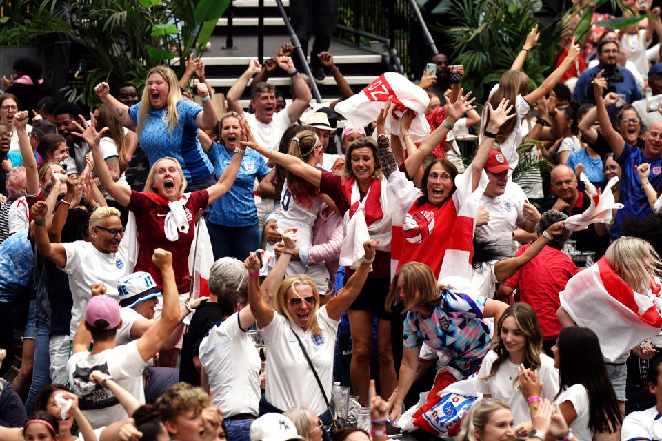 England fans celebrate following a screening of the FIFA Women's World Cup 2023 semi-final at BOXPARK Croydon, London. England will play Spain in the final of the Women's World Cup on Sunday after beating co-hosts Australia 3-1 in the semi-final in Sydney. Picture date: Wednesday August 16, 2023. (Photo by Aaron Chown/PA Images via Getty Images)