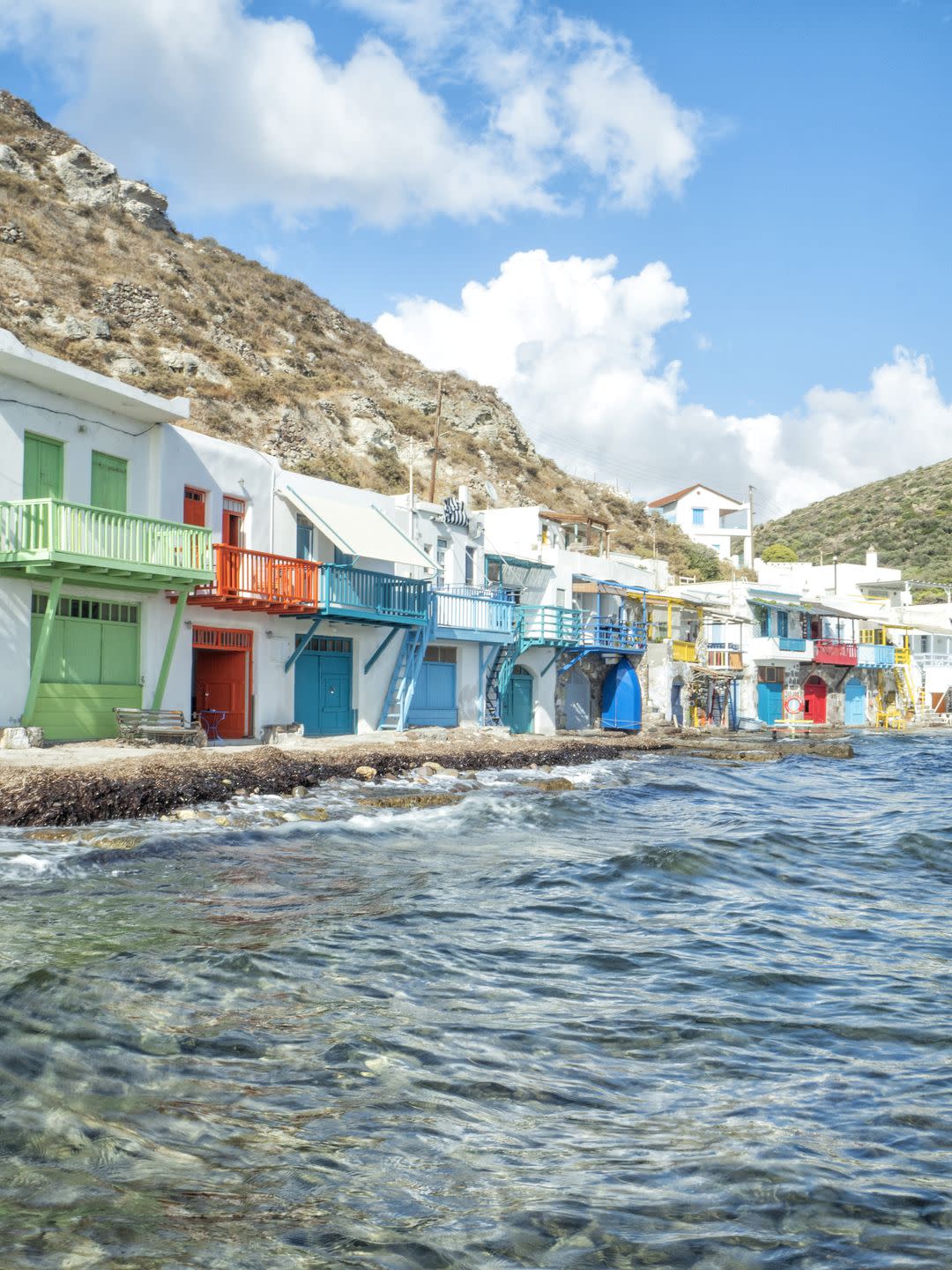 klima fishing village with bright coloured wooden doors milos island greece