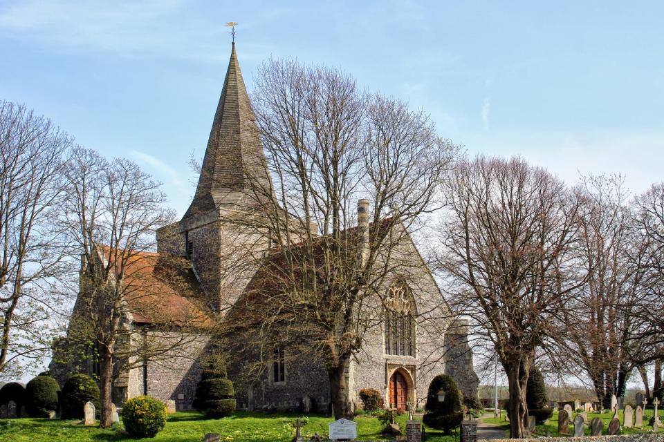 beautiful old sussex church in a rural setting the trees are waiting for spring