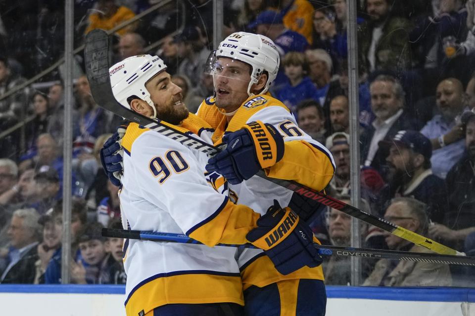 Nashville Predators' Cole Smith, right, celebrates with Ryan O'Reilly, left, after scoring a goal during the first period of an NHL hockey game against the New York Rangers, Thursday, Oct. 19, 2023, in New York. (AP Photo/Frank Franklin II)