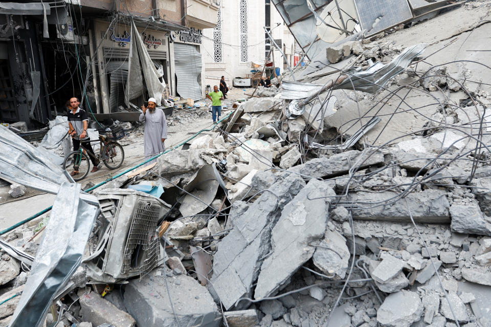 Palestinians inspect the damage in the aftermath of Israeli strikes, in Khan Younis, southern Gaza Strip October 10, 2023. REUTERS/Ibraheem Abu Mustafa