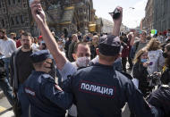 Police block protesters during a rally supporting Khabarovsk region's governor Sergei Furgal in St.Petersburg, Russia, Saturday, Aug. 1, 2020. Thousands of demonstrators rallied Saturday in the Russian Far East city of Khabarovsk to protest the arrest of the regional governor, continuing a three-week wave of opposition that has challenged the Kremlin. (AP Photo/Dmitri Lovetsky)