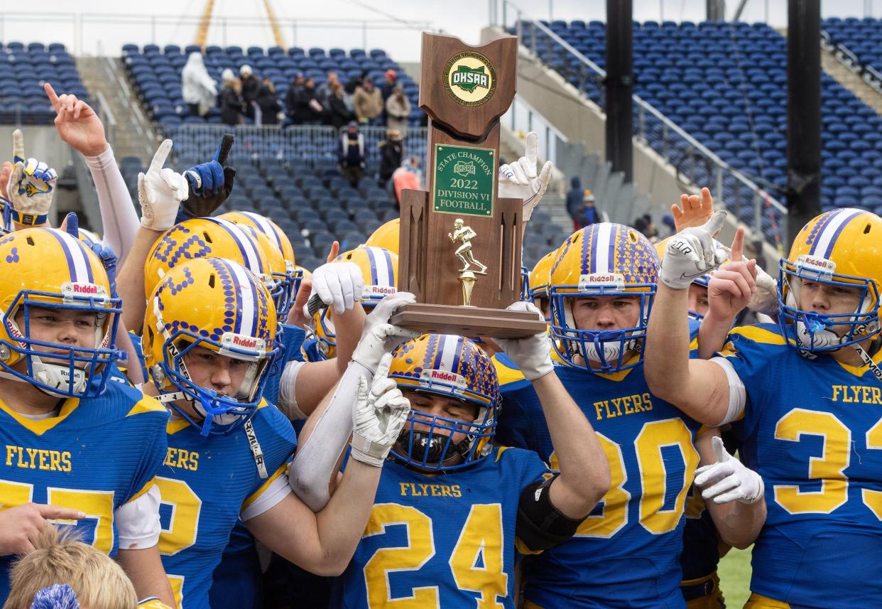 Marion Local’s Darren Meier holds up the Division VI state championship trophy after the Flyers defeated Kirtland on Saturday, Dec. 3, 2022, at Tom Benson Hall of Fame Stadium.