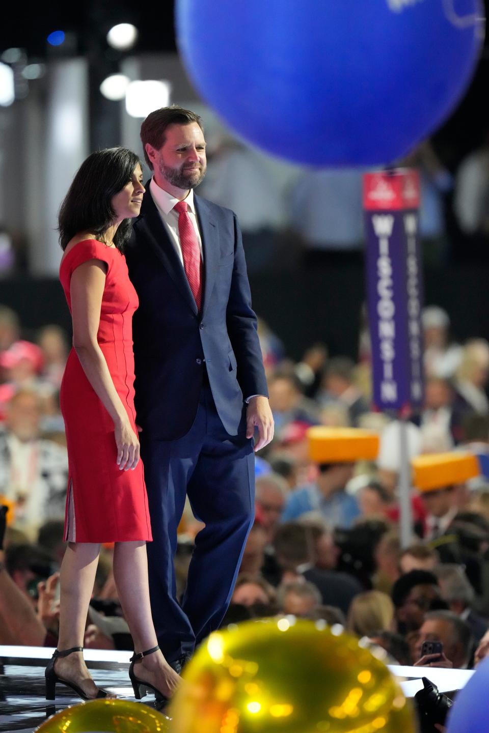 JD Vance and his wife, Usha Chilukuri Vance, stand on stage during a balloon drop on final day of the Republican National Convention in Milwaukee.