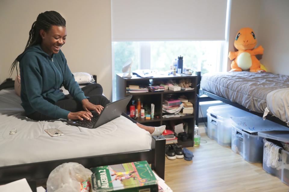 Former Wisconsin Lutheran High School international student Jolly Katugume, then a senior from Uganda, worked on her laptop in her dorm room at Honey Creek Hall in 2019. The school is seeking tax-exemption for the building.