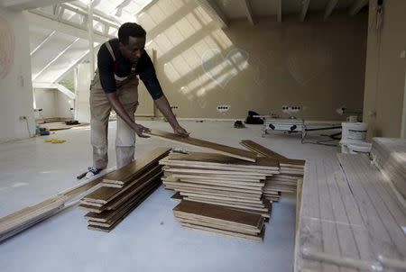 Tesfagebriel Abraha of Eritrea, 31, works during his apprenticeship for a parquet recliner in Dortmund, Germany, August 31, 2015. REUTERS/Ina Fassbender/Files