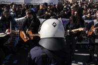 Artists play music during a protest outside parliament in Athens, Greece on Thursday, Feb. 2, 2023. Performing artists and arts students are striking for a second day, closing theatres, halting television shoots and disrupting art school classes, to protest charges in the qualification system of civil service jobs. (AP Photo/Thanassis Stavrakis)