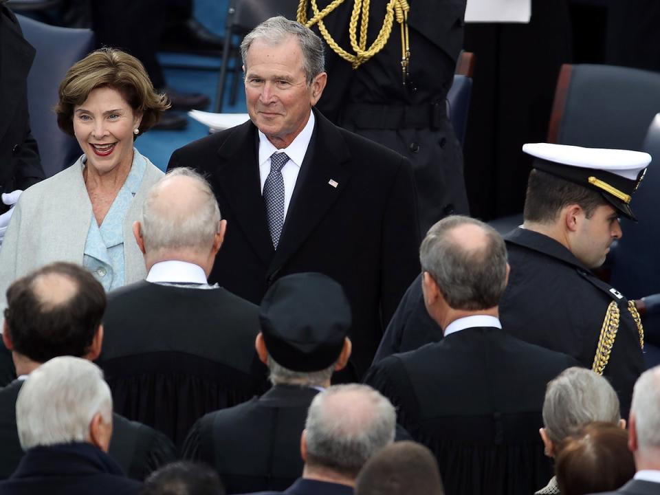 Former president George W. Bush and former first lady Laura Bush at the inauguration ceremony of Donald Trump in 2017. He has been poking fun at the advanced ages of both Joe Biden and Donald Trump in private speeches, according to a report (Getty Images)