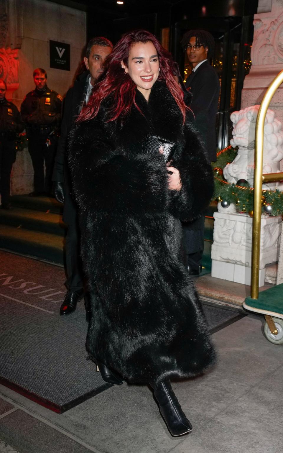 Dua Lipa pairing a full-length fur coat with high-heeled long boots