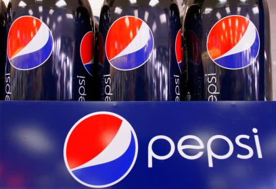 Bottles of Pepsi are dispalyed at a grocery store in Springfield, Ill., Wednesday, Feb. 9, 2011. PepsiCo Inc. said Thursday Feb. 10, its fourth-quarter net income fell 5 percent despite a surge in revenue as it faced higher costs.( AP Photo/Seth Perlman)