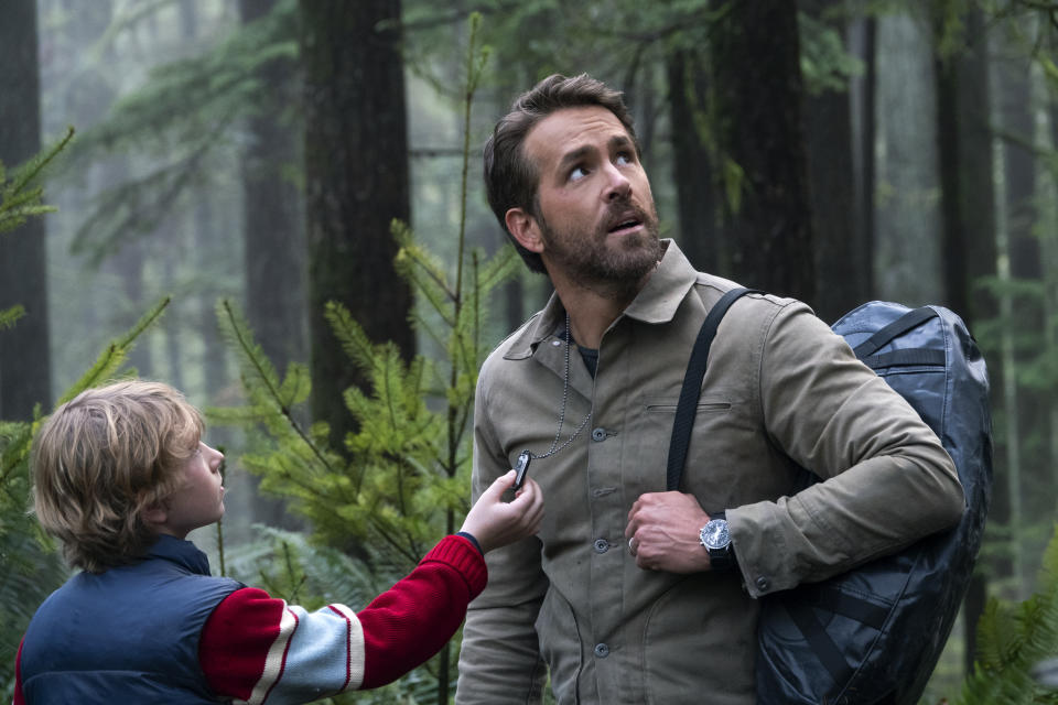 This image released by Netflix shows Walker Scobell, left, and Ryan Reynolds in a scene from "The Adam Project." (Doane Gregory/Netflix via AP)