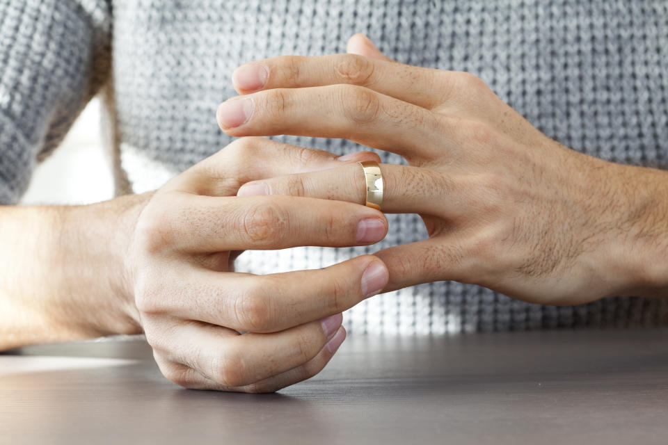 Man taking off wedding ring