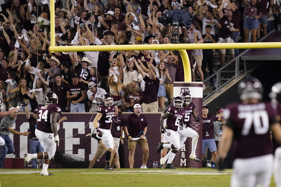 Texas A&M's Devon Achane (6) and fans celebrate after he scored on a 96-yard kickoff return against Alabama during the second half of an NCAA college football game Saturday, Oct. 9, 2021, in College Station, Texas. (AP Photo/Sam Craft)
